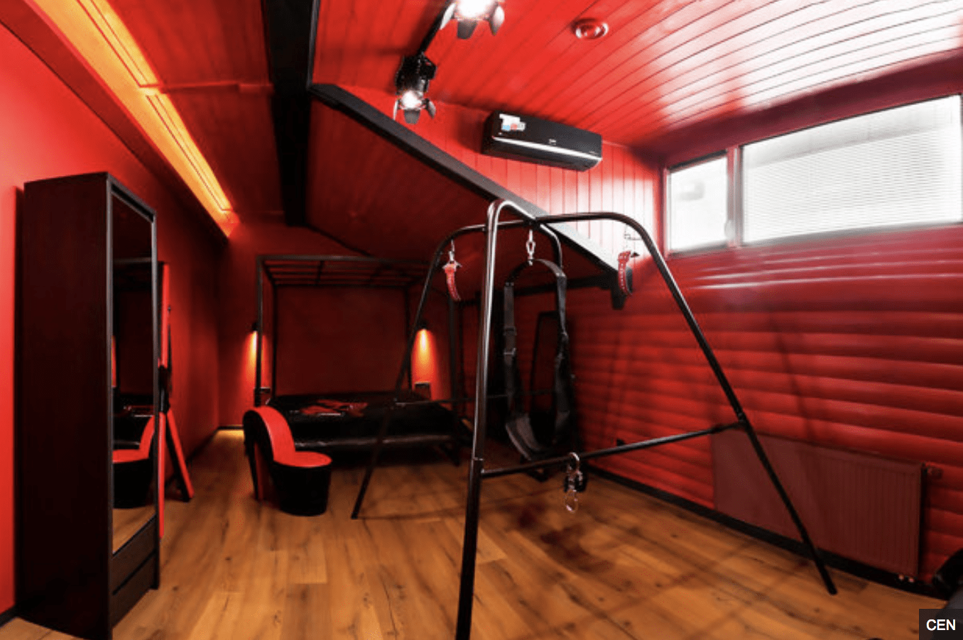 S&M Hotel For Kinky Couples Opens In Ukraine- red wall and furniture with wooden floors